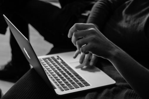 grayscale-photo-of-person-using-mac-book.jpg grayscale photo of person using MacBook